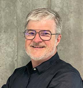 Three women holding a one tree planted sign in a forrest