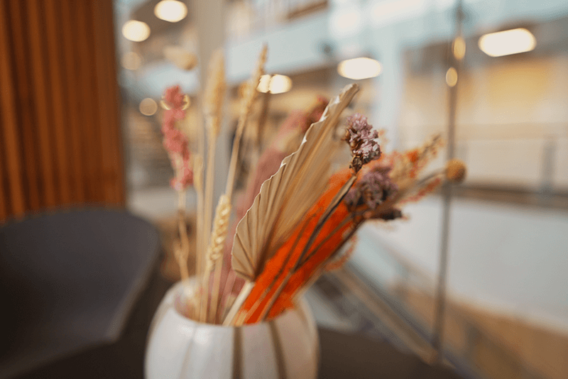 Flower pot with dried flowers on a blurred background